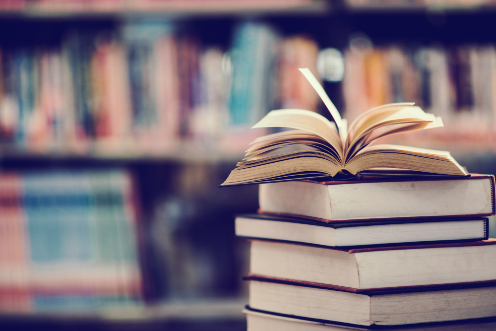 Open book in a stack in library