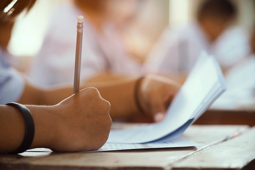 Student holding a pencil taking a test